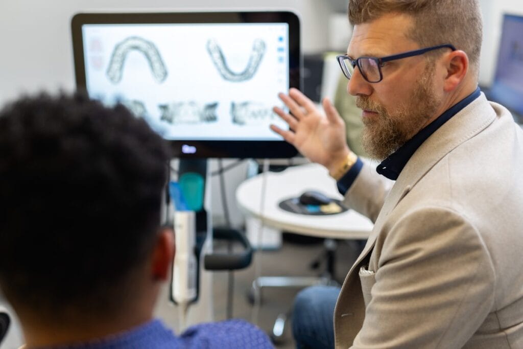 The Financing Advantage Most GP Orthodontic Programs Are Missing 2 Dr. Jason Gladwell reviewing a digital scan with a patient