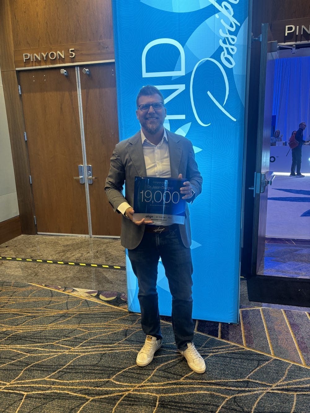Beyond Possible: What We Took Away from the 2026 Invisalign Ortho Summit 4 Dr. Jason Gladwell holding his 19,000 Invisalign cases award at the 2026 Ortho Summit